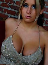 Sexy busty wrestler Tara playing around in a tight top on the couch